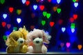 A pair of stuffed dogs on a blurred background in the shape of love