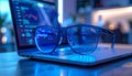 Digital Focus: Blue Light Glasses on Laptop with Code Royalty Free Stock Photo