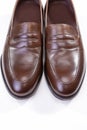 Pair of Stylish Brown Penny Loafer Shoes Against White Background