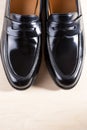 Pair of Stylish Expensive Modern Leather Black Penny Loafers Shoes.Closeup Shot