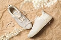 Pair of stylish shoes with laces on crumpled craft paper, flat lay