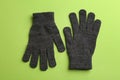 Pair of stylish woolen gloves on green background, flat lay Royalty Free Stock Photo