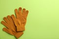 Pair of stylish woolen gloves on green background, flat lay. Space for text Royalty Free Stock Photo