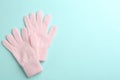 Pair of stylish woolen gloves on light blue background, flat lay. Space for text Royalty Free Stock Photo