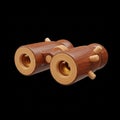 Stylized wooden binoculars with a warm brown finish and light wood accents on a black background Royalty Free Stock Photo