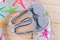 A pair of summer shoes and a colored circle for swimming lie on wooden boards, the concept of summer, vacation