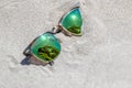 Pair Of Sunglasses On The Beach With A Reflection Of A Beautiful Royalty Free Stock Photo