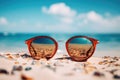 A pair of sunglasses resting on the warm sand of a beach, ready to shield your eyes and enhance your beach experience, Sunglasses