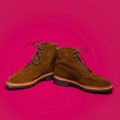 Pair of Tan Brown Suede Split Toe High Boots Closeup With Rude Rubber Sole Placed Together On Red Background Royalty Free Stock Photo