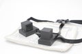 Pair of tefilin and Tallit A symbol of the Jewish people, a pair of tefillin with black straps, on a white background, wi