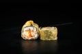 Pair of tempura rolls kioto close-up on a dark background