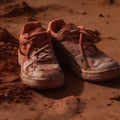 A pair of tennis shoes covered in red clay after a hard-f created with generative AI