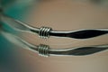 a pair of three twisted wire bracelets on a table Royalty Free Stock Photo