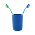 Pair of toothbrushes in blue plastic cup isolated over white background Royalty Free Stock Photo