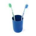 Pair of toothbrushes in blue plastic cup isolated over white background Royalty Free Stock Photo