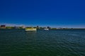 A pair of tour boats traverse the St.Marys River with Sault Ste Marie ON Canada behind