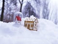 A pair of toy decorative houses with lighted illumination on the snow