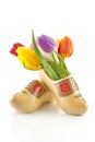 Pair of traditional Dutch wooden shoes with tulips Royalty Free Stock Photo