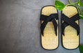 Pair of traditional japanese bamboo zori shoes. Top view of sandals with decorative greenery Royalty Free Stock Photo