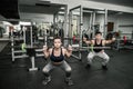 Pair training instructor with woman, both holding dumbbells Royalty Free Stock Photo