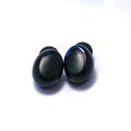 A pair of truly wireless earbuds on a pure white background with shadows