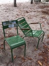 Pair of two empty garden chairs touching each other in Paris park Royalty Free Stock Photo