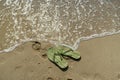 Pair, two of men`s beach slippers on the sand Royalty Free Stock Photo