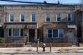 Two Old Brick Homes Side by Side along an Empty Street and Sidewalk in Astoria Queens New York