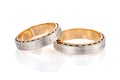 Pair of two tone gold wedding ring with matte surface and diamonds isolated on white background Royalty Free Stock Photo