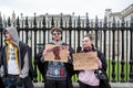 Pair of University students seen at a peaceful protest, while holding protest signs.