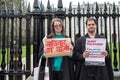 Pair of University students seen at a peaceful protest, while holding protest signs.