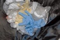 Used blue Nitrile gloves in the trash