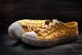 Pair of used old fashioned sneakers shoes on dark wooden surface Royalty Free Stock Photo