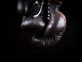 Pair of very old brown boxing gloves hanging Royalty Free Stock Photo