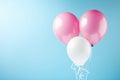 A pair of vibrant pink and white balloons gracefully soaring through the sky, a colorful gender reveal with pink and blue balloons Royalty Free Stock Photo