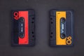 Pair of vintage audio cassettes over a black chalkboard Royalty Free Stock Photo