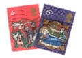 A pair of vintage 4d and 5d Christmas postage stamps from Great Britain.