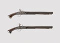 Pair of vintage pistols or muskets on a white bac