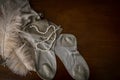 A pair of vintage stockings, a feather, and pearls on a dressing table