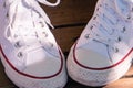 Pair of vintage style canvas sport white sneakers. Close up.