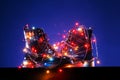 A pair of warm autumn black womens boots with fairy lights