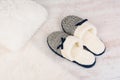 Pair of warm female slippers on white furry carpet Royalty Free Stock Photo