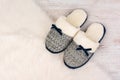 Pair of warm female slippers on white furry carpet Royalty Free Stock Photo