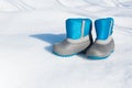 Pair of waterproof children boots on the snow