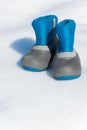 Pair of waterproof children boots on the snow