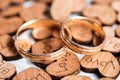 Pair wedding gold rings on wooden hearts with scorched inscription Love on white background Royalty Free Stock Photo