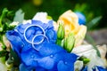 Pair of wedding rings on the background of the bridal bouquet Royalty Free Stock Photo