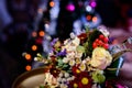 Pair of wedding rings lying on a colorful bouquet with different flowers over the blurred background Royalty Free Stock Photo