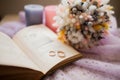 Pair of wedding rings. Retro background with old book and bouquet of dry flowers Royalty Free Stock Photo