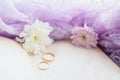 Pair of wedding rings. Retro background with old book and chrysanthemums